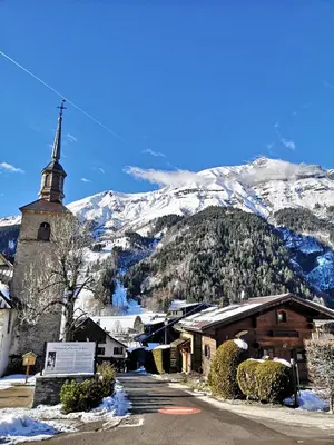 a village covered in snow in a mountain at Nice & cozy apartment facing the gondola - LA BOULE DE NEIGE 112 in Les Contamines-Montjoie