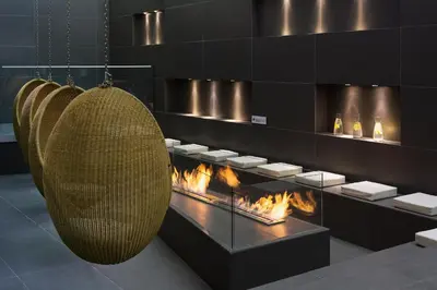 a room with a fireplace and a hanging basket at Heliopic Hotel & Spa in Chamonix-Mont-Blanc