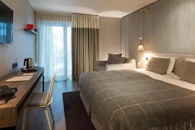 a hotel room with a bed and a desk at Heliopic Hotel & Spa in Chamonix-Mont-Blanc