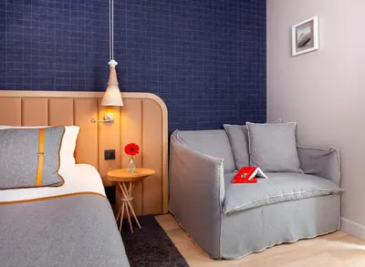 a room with a couch and a bed and a table at Heliopic Hotel & Spa in Chamonix-Mont-Blanc