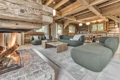 a living room with a couch and a fireplace at Le Hameau du Renard Blanc in Saint-Gervais-les-Bains