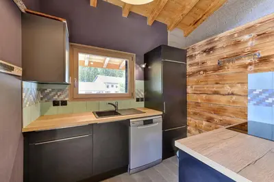 a kitchen with a sink and a counter top at Chalet le petit Nicolas, jacuzzi, vue Mont Blanc in Chamonix-Mont-Blanc
