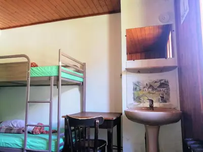 a bathroom with a sink and a bunk bed at Le Chamoniard Volant in Chamonix-Mont-Blanc