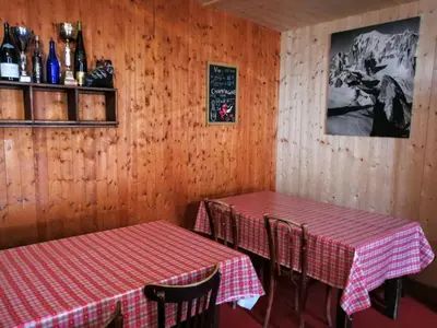two tables in a restaurant with red and white checkered table cloth at Le Chamoniard Volant in Chamonix-Mont-Blanc