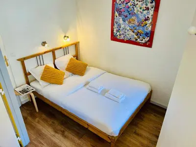 a bedroom with a bed with yellow pillows on it at Appt cosy au centre de Chamonix in Chamonix-Mont-Blanc