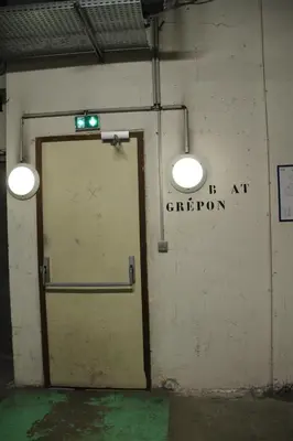 a door in a building with a green sign on it at Appt cosy au centre de Chamonix in Chamonix-Mont-Blanc