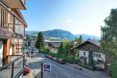 a view of a town with cars parked on a street at La Ménandière in Megève