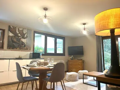 a kitchen and dining room with a table and chairs at Appartement style chalet avec grande terrasse et parking prive in Chamonix-Mont-Blanc