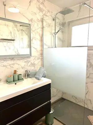 a bathroom with a sink and a shower at Appartement style chalet avec grande terrasse et parking prive in Chamonix-Mont-Blanc