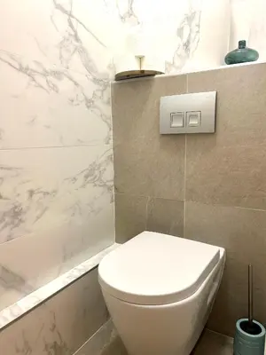 a bathroom with a white toilet and a bath tub at Appartement style chalet avec grande terrasse et parking prive in Chamonix-Mont-Blanc