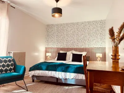 a bedroom with a bed and a desk and a chair at Appartement style chalet avec grande terrasse et parking prive in Chamonix-Mont-Blanc