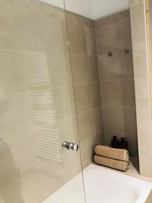 a shower stall with a glass door in a bathroom at Mont Blanc 43, vue Mont Blanc , balcon, parking in Chamonix-Mont-Blanc