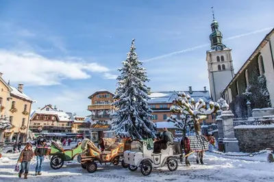 a group of old fashioned vehicles parked in a snowy town at Chalet Roseau in Megève