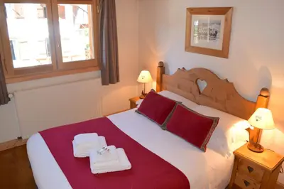 a living room with leather furniture and a fireplace at Chalet Roseau in Megève