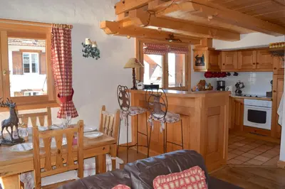 a living room with leather furniture and a fireplace at Chalet Roseau in Megève
