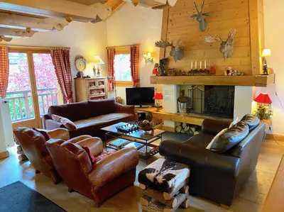 a bedroom with a large bed with towels on it at Chalet Roseau in Megève