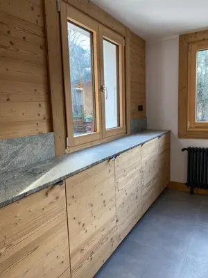 a kitchen with wooden cabinets and a window at 4 Bedroom, 4 Bathroom, Hot Tub, Chamonix Centre in Chamonix-Mont-Blanc