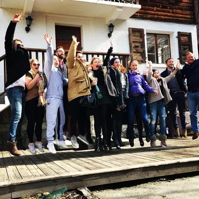 a group of people standing on a porch with their hands in the air at 4 Bedroom, 4 Bathroom, Hot Tub, Chamonix Centre in Chamonix-Mont-Blanc