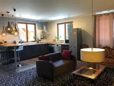 a living room with a couch and a kitchen at Nant d Ant in Samoëns