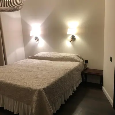 a bedroom with a bed and two lights on the wall at Nant d Ant in Samoëns