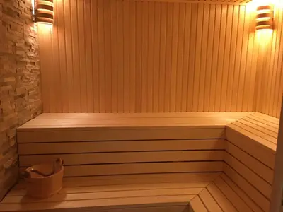a wooden sauna with a bench in a room at Nant d Ant in Samoëns