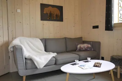 a living room with a couch and a table at Les Ours de Combloux in Combloux