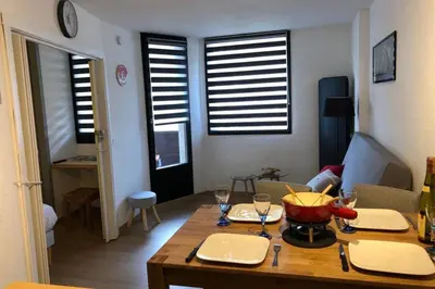 a living room with a table with wine glasses at Chamonix sud -Le Grepon in Chamonix-Mont-Blanc
