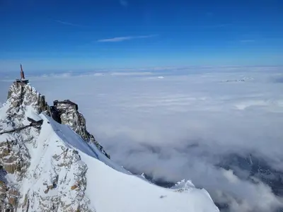 a view of a mountain with snow and clouds at Chamonix sud -Le Grepon in Chamonix-Mont-Blanc