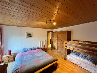 a bedroom with a bed and a wooden ceiling at Appartement spacieux proche des télécabines et du centre ville avec jardin privé in Saint-Gervais-les-Bains
