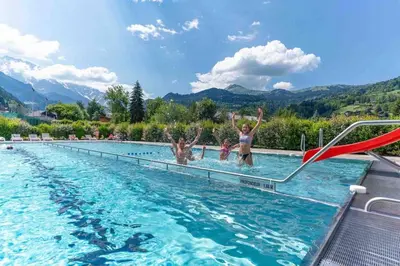 a group of people in a swimming pool at Appartement spacieux proche des télécabines et du centre ville avec jardin privé in Saint-Gervais-les-Bains