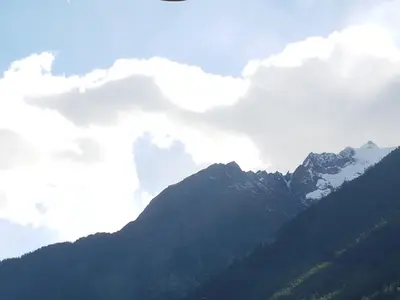 a view of a mountain with clouds in the sky at Appartement Cham-Vue in Chamonix-Mont-Blanc