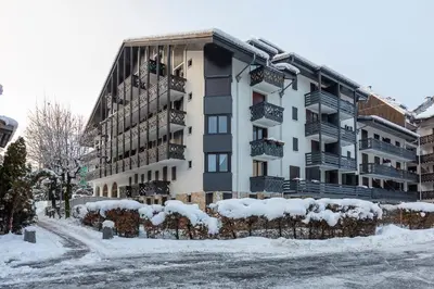 an apartment building with snow on the ground at Appartement Cham-Vue in Chamonix-Mont-Blanc