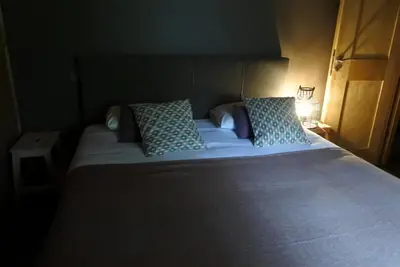 a large bed with blue pillows in a bedroom at Grand chalet Le Trappeur - Chamonix in Chamonix-Mont-Blanc
