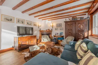 a living room with a couch and a tv at Chalet Ecureuil - Happy Rentals in Chamonix-Mont-Blanc