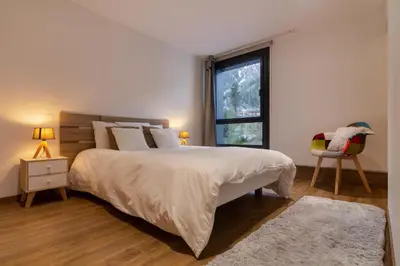 a bedroom with a large bed and a window at Chic 1BR ideally located in the city center in Chamonix-Mont-Blanc