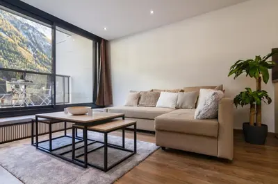 a living room with a couch and a table at Chic 1BR ideally located in the city center in Chamonix-Mont-Blanc