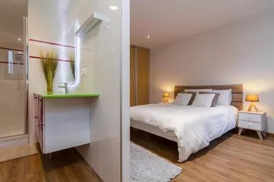 a living room with a couch and a large window at Chic 1BR ideally located in the city center in Chamonix-Mont-Blanc