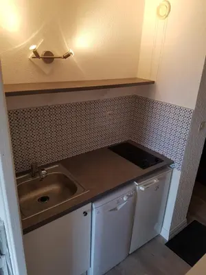 a small kitchen with a sink and a counter at Studio tout confort avec vue sur les sommets in Combloux