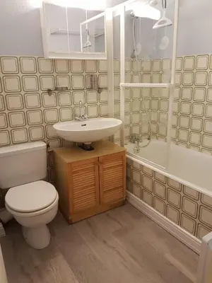 a bathroom with a toilet and a sink and a tub at Studio tout confort avec vue sur les sommets in Combloux