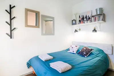 a bedroom with a blue bed with two pillows at Nid douillet a proximite des pistes in Chamonix-Mont-Blanc