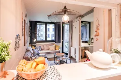 a kitchen and living room with a bowl of fruit on a table at Nid douillet a proximite des pistes in Chamonix-Mont-Blanc