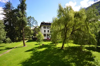 a house in the middle of a field with trees at Nid douillet a proximite des pistes in Chamonix-Mont-Blanc