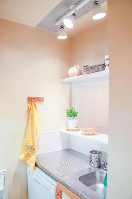 a kitchen with white counters and a sink at Nid douillet a proximite des pistes in Chamonix-Mont-Blanc