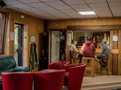 a group of people in a room with red chairs at Auberge de Jeunesse HI Chamonix in Chamonix-Mont-Blanc