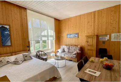 a bedroom with a bed and a table and a couch at Résidence du Mont-Blanc n°5Bis in Combloux