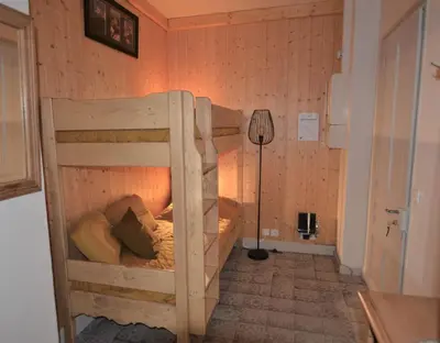 a bedroom with two bunk beds in a room at Résidence du Mont-Blanc n°5Bis in Combloux