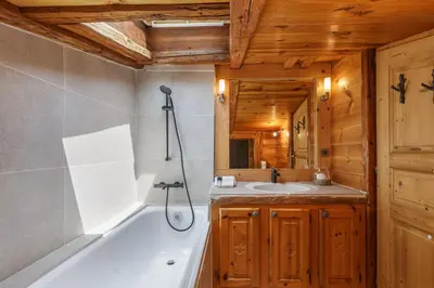 a bathroom with a bath tub and a sink at Le Beaulieu - Happy Rentals in Chamonix-Mont-Blanc