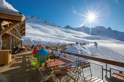 a group of people sitting on a ski slope at Le Beaulieu - Happy Rentals in Chamonix-Mont-Blanc