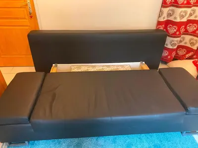 a black bed sitting in a room at Chalet Champraz Studio - Free Parking in Chamonix-Mont-Blanc