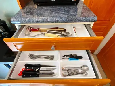 a drawer full of utensils in a cabinet at Chalet Champraz Studio - Free Parking in Chamonix-Mont-Blanc